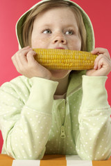 Girl eating a corncob