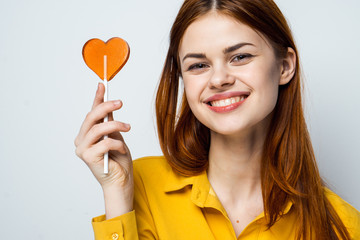 portrait woman smiling with lollipop