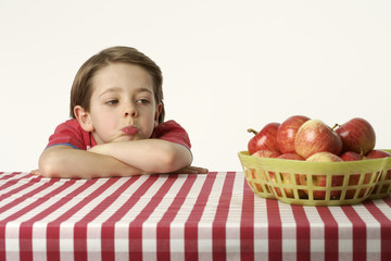 Boy looking at apples