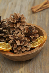 Dish with pine cones and orange slices