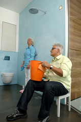 Senior couple cleaning bathroom
