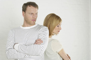 Fototapeta premium Frustrated couple standing back to back
