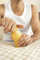 Young man opening a bottle of juice