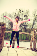 Woman exercising with dumbbells outdoor