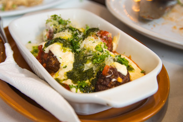 homemade meatballs baked with tomato, cream and pesto sauce
