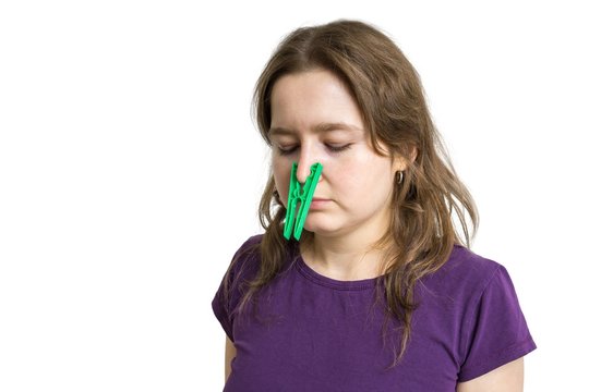 Pollen Allergy Concept. Young Woman Cant Breathe And Wearing Peg On Her Nose. Isolated On White Background.