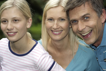 Mother, father and daughter smiling, selective focus