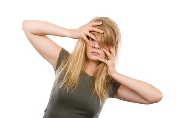 Ashamed embarrassed blonde woman with hands on face