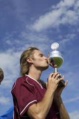 Kicker kissing a cup
