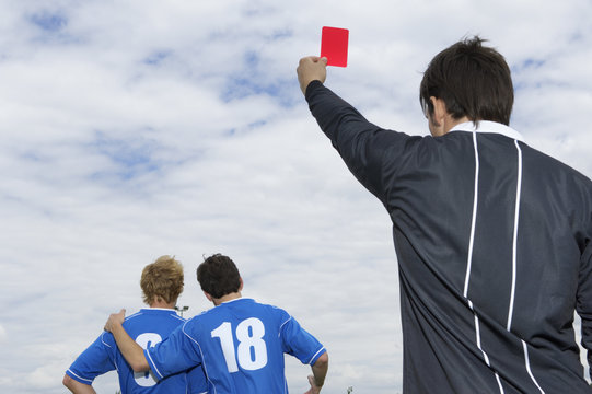 Referee showing red card to kicker