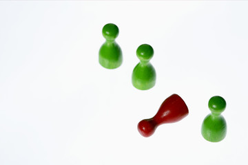 Lying red game piece between green ones