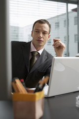 Mature man sitting in front of a laptop