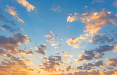 Dramatic sky background include sunset or sunrise, abstract cloud look fluffy. Represent weather, wind, heaven, freedom and god. Colorful with yellow, orange and blue color at evening in autumn. 