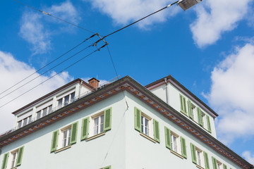 Fototapeta na wymiar European Town House Shutters Windows Corner Perspective Architectural Shot Blue Sky Clouds