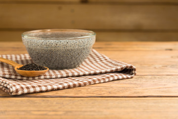 Lemon basil seeds on wood table. Healthy food for those who want to lose weight.