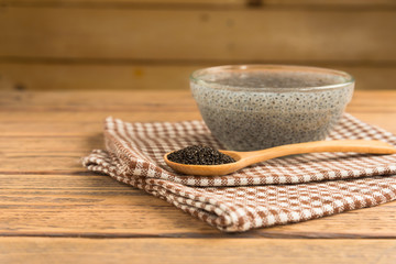 Lemon basil seeds on wood table. Healthy food for those who want to lose weight.
