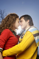 Teenage couple is about kissing one another, close-up, low angle view