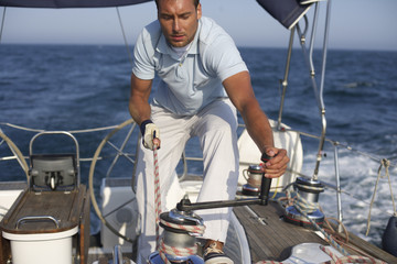 Man working on a yacht, truncated