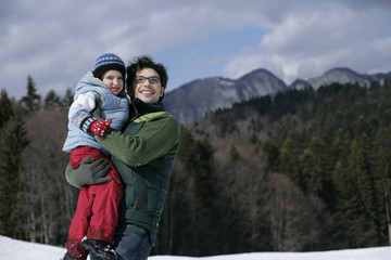 Obraz premium Young man holding his son
