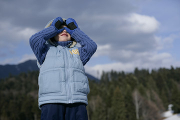 Fototapeta premium Boy using hands as spyglass