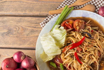 Papaya salad on wood table. Papaya salad  has a name that Thai people called 