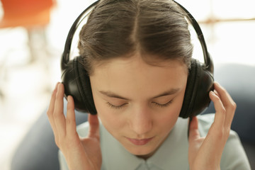 Girl listening to music by earphones