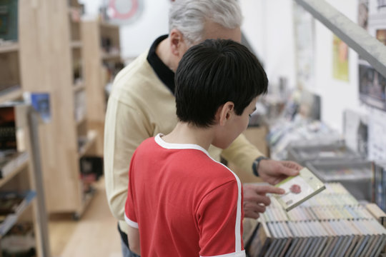 Grandfather and boy choosing CDs, fully_released