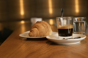 A croissant an a cup of coffee