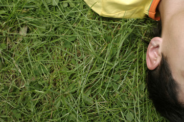 Young man lying on grass