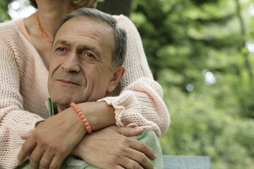 Mature woman embracing her husband