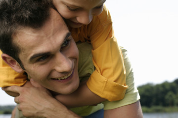 Father giving son a piggyback ride