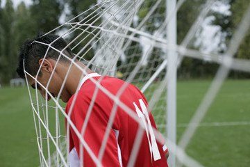 Soccer player's head in the goal net