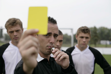 Referee showing the yellow card