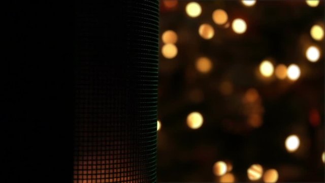 Glowy Speaker playing music with defocused christmas lights in background