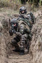 Paratroopers of french 1st Marine Infantry Parachute Regiment RPIMA in entrenchments, pointing to camera front view