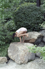 Fototapeta na wymiar Woman doing Yoga on a Rock - Harmony - Nature - Buddhism