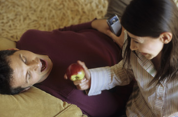Woman offering an Apple to her boyfriend