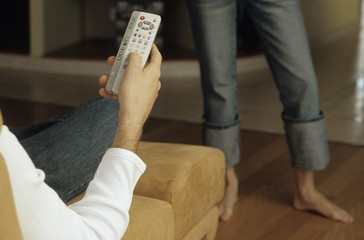 Woman standing between TV and Boyfriend - Media - Relationship - Living Room