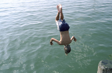 Boy jumping headlong into Water - Swimming - Leisure Time - Youth