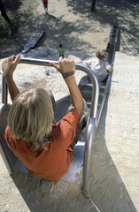 Blonde Boy at the upper End of a Slide - Playground - Summer