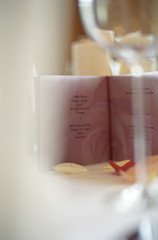 Fototapeta premium Menu Card on a Table with Rose Petals on it - Decoration - Party - Wedding