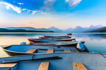 boats at dock on peaceful lake at sunset