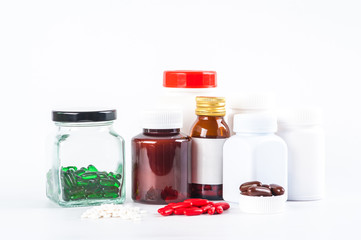 Composition of medicine bottles and pills isolated on white, Pills spilling out of pill bottle on white background. view with copy space. Medicine concept