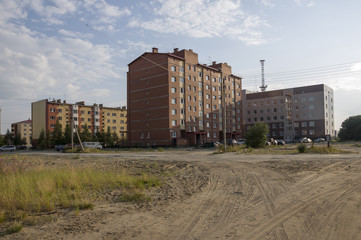 Fototapeta na wymiar Modern multi-storeyed buildings with telecommunications tower behind