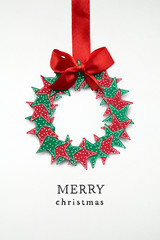 Christmas wreath / Creative concept photo of christmas wreath with bow made of paper on white...