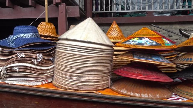 Boat with hats on floating market Damnoen Saduak in Bangkok, Thailand, 4k
