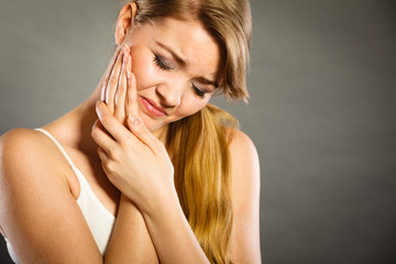 Woman suffering from tooth pain