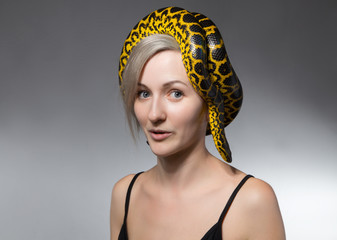 Woman and snake on her head