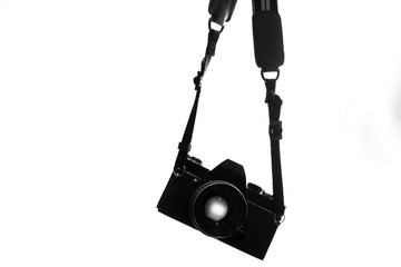 Old black camera hanging on white background