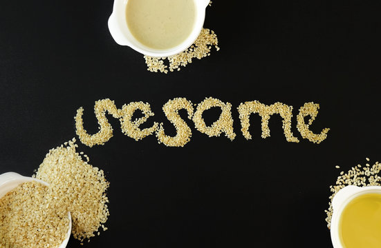 sesame word with sesame seeds on black background